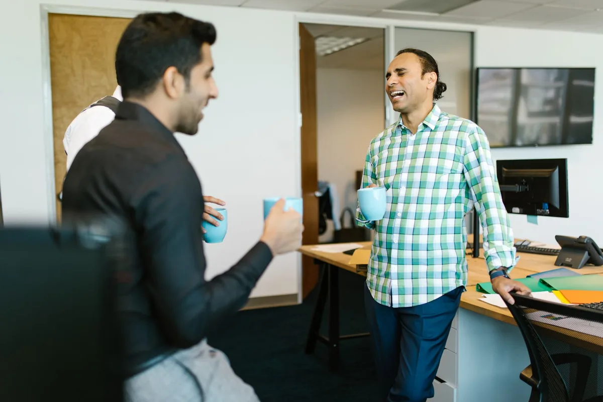Colegas de trabalho conversando durante uma pausa no escritório